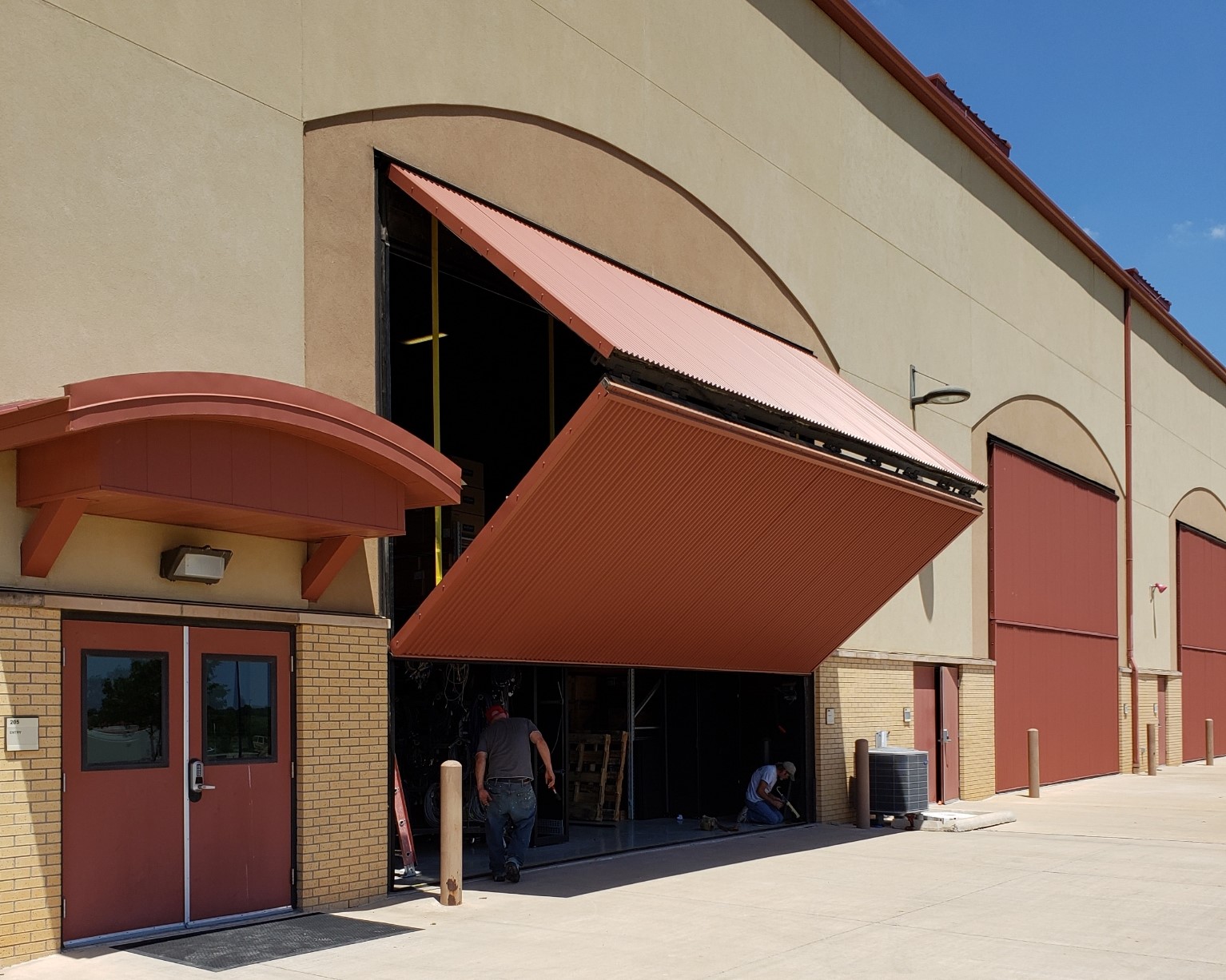 Commercial facility with custom hydraulic door installed by Clear Creek Developments in Southwest Oklahoma